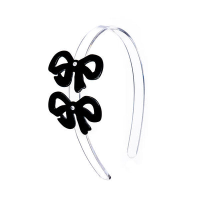 Clear acrylic headband adorned with two black bows 