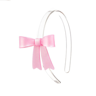 Clear headband adorned with a pink statement bow