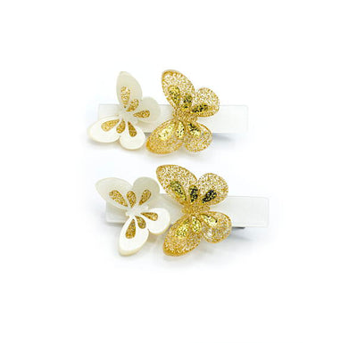 Pair of metal hair clips adorned with a white acrylic base and two sparkly butterflies on each. 