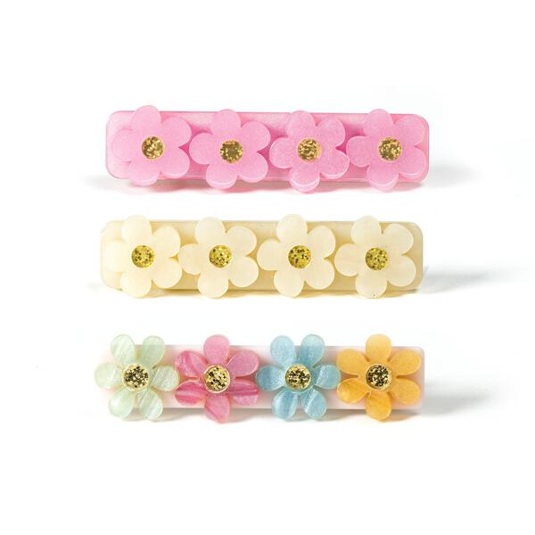 Trio of hair clips. All adorned with four flowers but in different colors. The first one is pink, the second one is beige and the third one has four flowers in different colors: light green, light pink, light blue and light orange. 