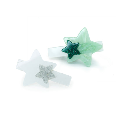Set of two acrylic hair clips featuring star charms in green and white.