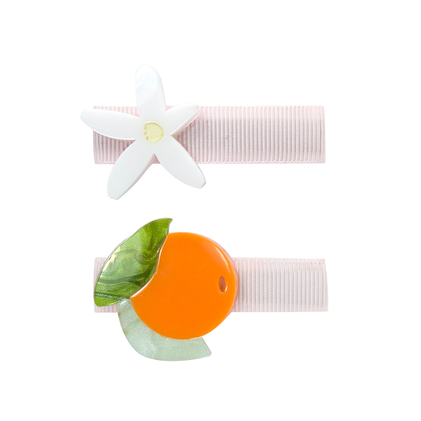 Pair of hair clips. One is adorned with a tangerine and the other one with a white, five petals flower. 