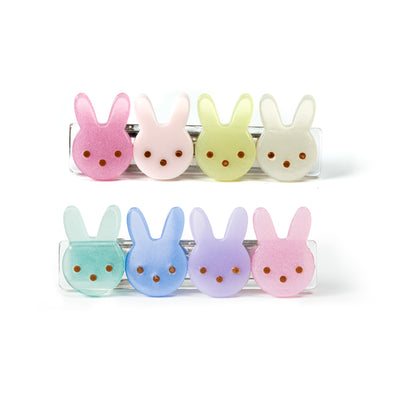 Pair of hair clips adorned with four colorful bunny faces each. 