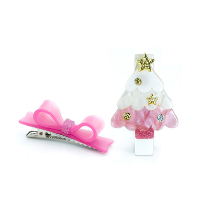 Hair clip set of two different charms. One is a pink pearlized Christmas tree with gold glitter decorations and the other one is a pink pearlized bow.