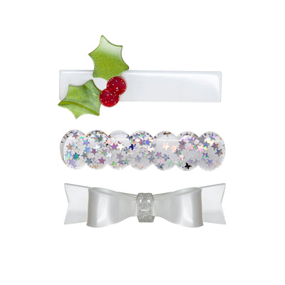 Acrylic set of three hair clips. One is a pearly bow tie, one is a clear cut out with shiny stars and the last one is rectangular adorned with a glitter mistletoe.