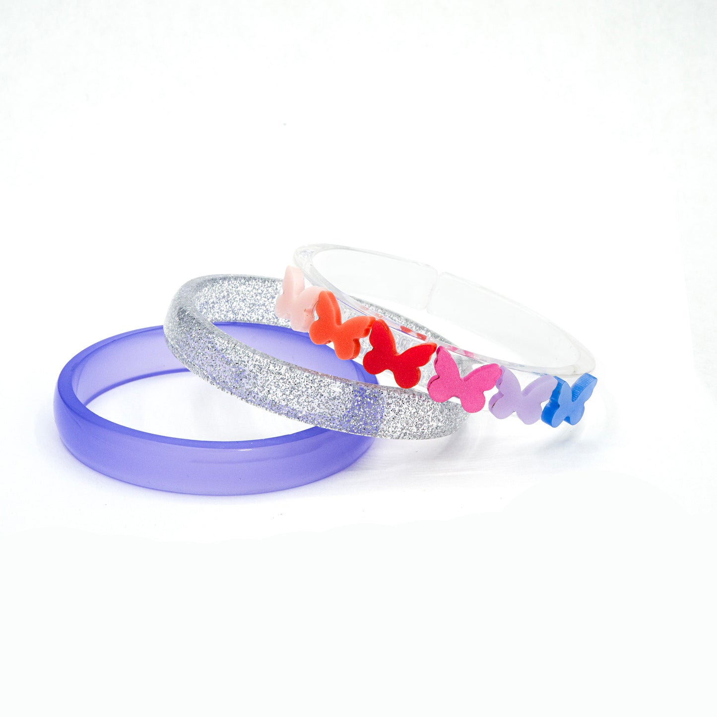 Set of three acrylic bracelets in different colors. One is silver glitter, one is purple and the third one is clear and adorned with six colorful butterflies. 