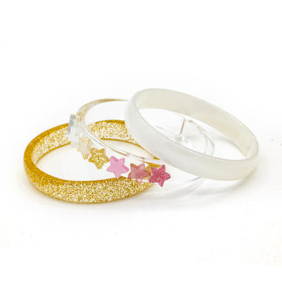 Set of three acrylic bangles. One is gold glitter, one is pearly white and the third one is clear with seven stars in pink, gold and white. 