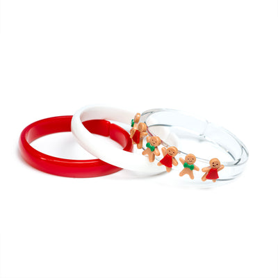 Set of three acrylic bangles. One is red, one is white and one clear with gingerbread cookie charms. 