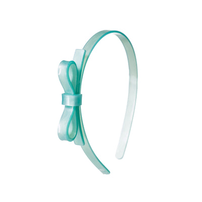 Acrylic headband adorned with a thin side bow. Mint pearly color. 