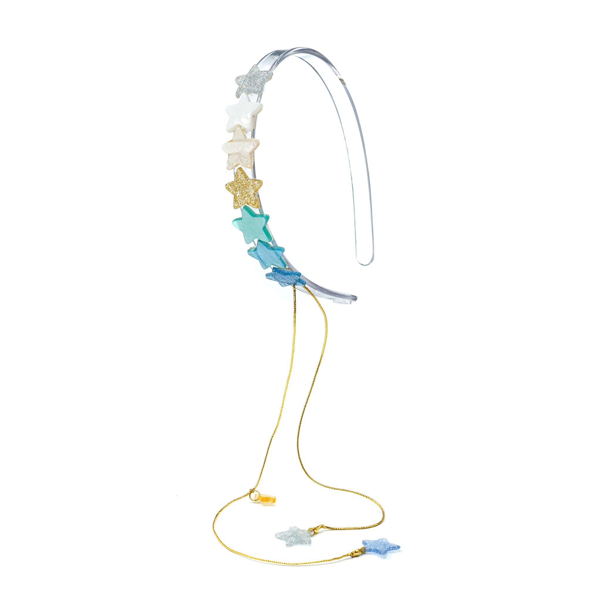 Clear acrylic headband adorned with seven small stars in different shades of blue, green, gold, white and silver. It also has two stars hanging from gold strings. 