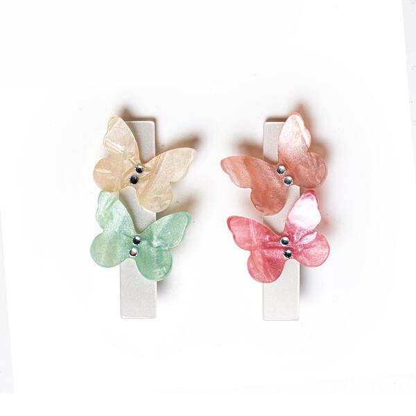 Pair of hair clips, each adorned with two pastel color butterflies.