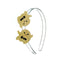 A gold-colored headband with two decorative glittery ghost shapes on it.